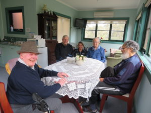 Monday Respite men sitting with Leanne at a table in Maldon