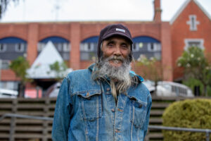 Traditional Owner Uncle Rick standing in front of the Castlemaine Health hospital